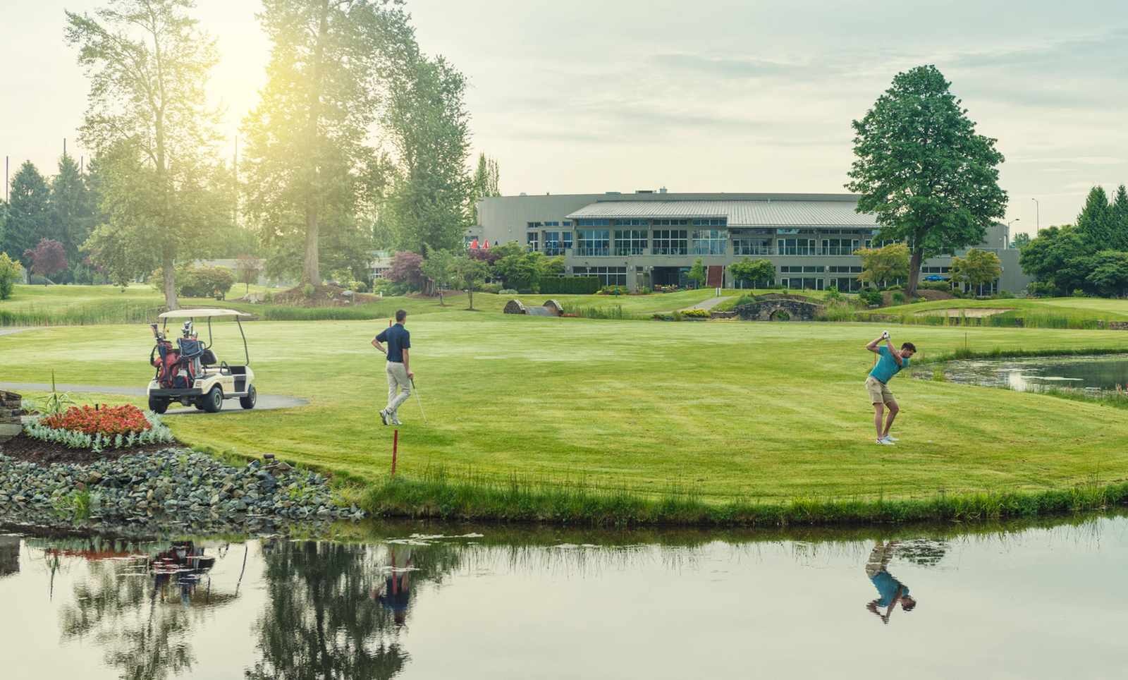 Golfers on the course in front of the clubhouse