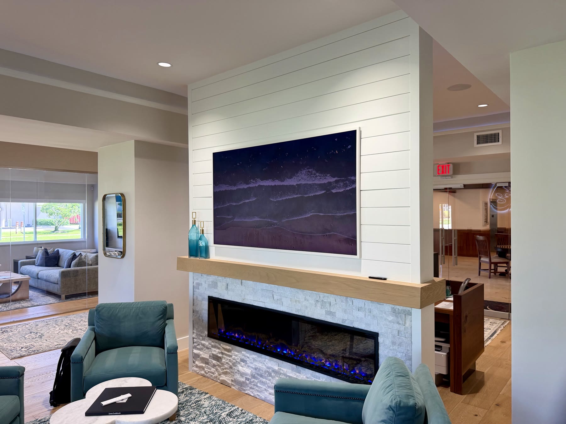 Experience Center media wall with integrated display, fireplace, and lighting