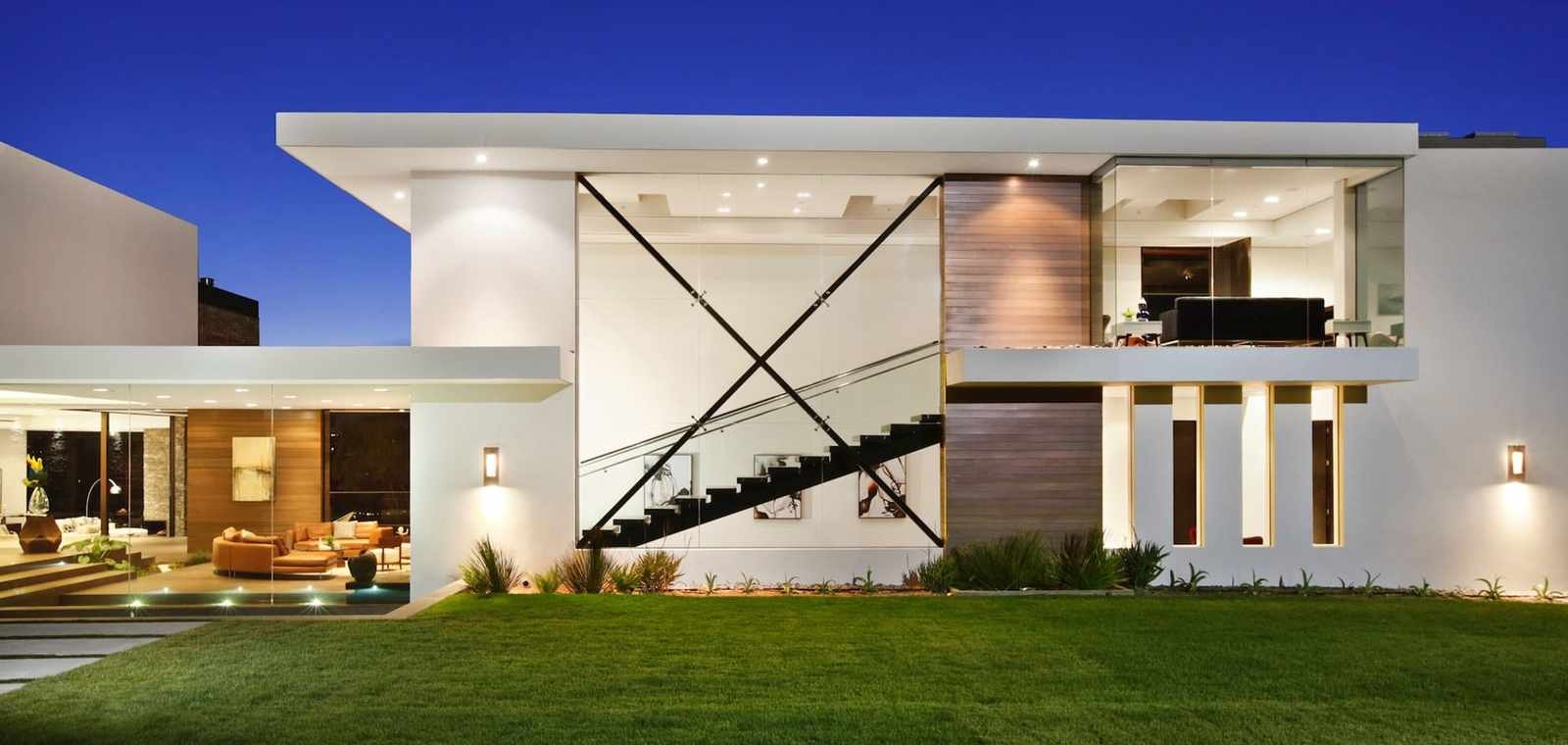 Modern home exterior with layered architectural lighting at night