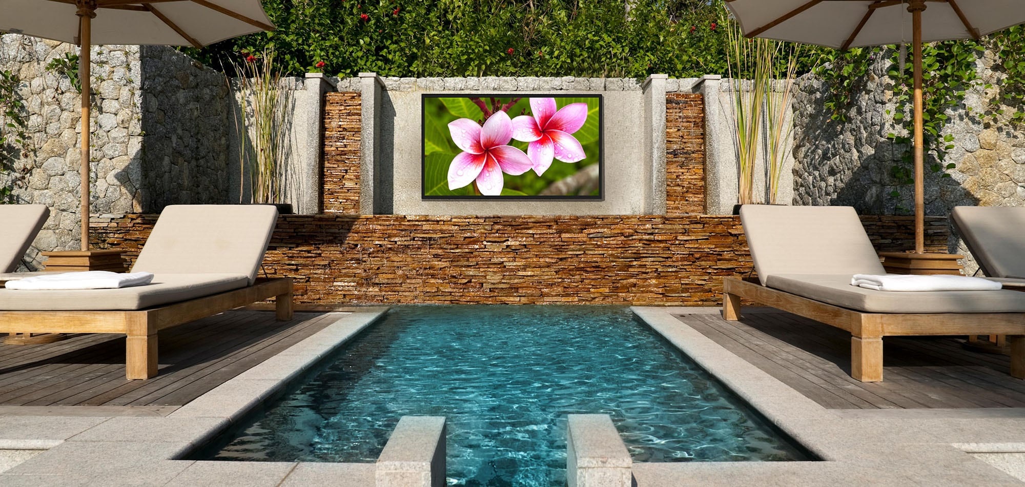 Weather-proof TV mounted by the pool